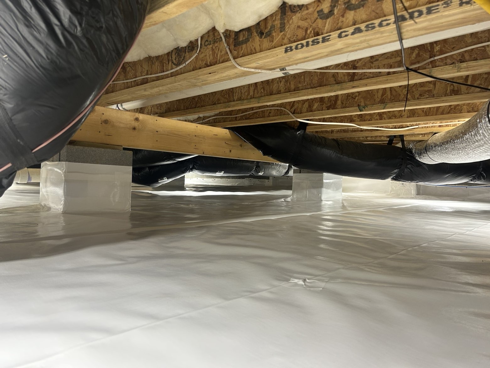 Wrapped HVAC ducts and sealed moisture control system in encapsulated crawlspace